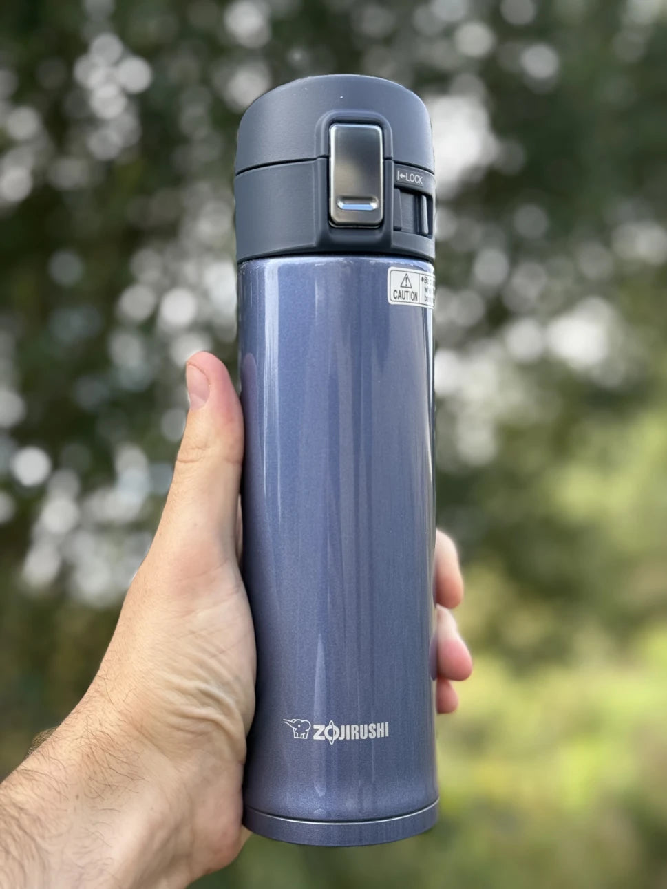 Zojirushi insulated travel mug SM-KHE in dark blue, lightweight stainless steel thermal bottle for hot and cold drinks.