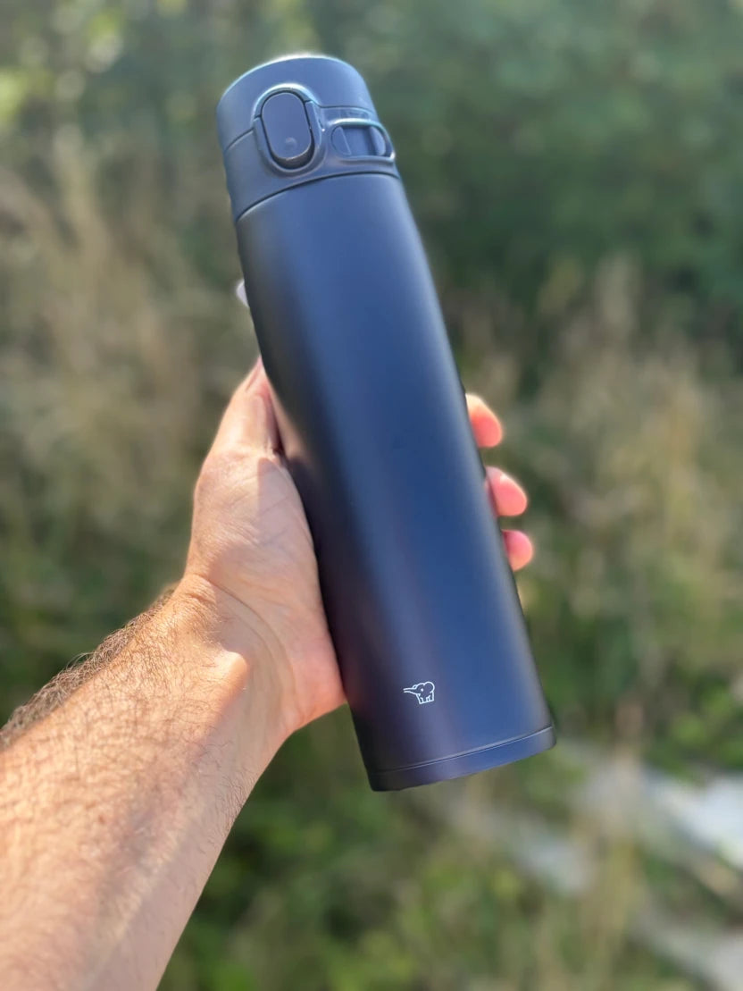 Zojirushi SM-VA72 Dark Blue travel mug held outdoors, 600 ml (20.30 oz) to 720 ml (24.40 oz)
