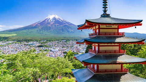 View of Mount Fuji with snow-capped peak and Chureito Pagoda in the foreground, overlooking Fujiyoshida city, Japan.